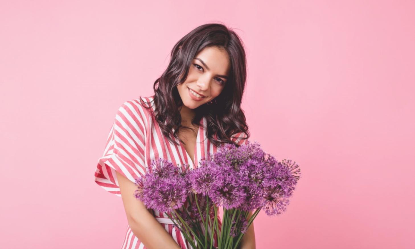 Hands arranging flowers during a focused floristry masterclass
